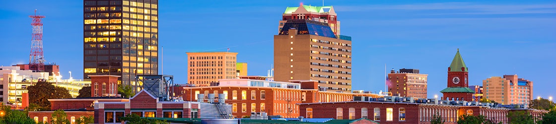 New Hampshire’s Senate Bill 416 requires employers to consider employee requests for more flexible schedules. It also prohibits employers from taking disciplinary action against employees who ask for a more flexible work schedule. Manchester, New Hampshire cityscape.