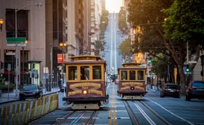 More and more cities and states have predictive scheduling laws. Get our free 2018 guide. Photo of San Francisco cable cars.